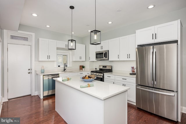 2621 E Monument St, Baltimore, MD 21205 - kitchen featuring stainless steel appliances, a sink, white cabinetry, dark wood-style flooring, and a kitchen island