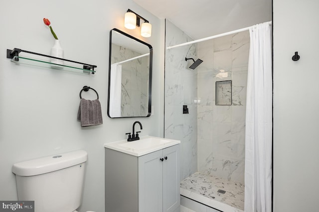 2621 E Monument St, Baltimore, MD 21205 - bathroom featuring toilet, vanity, and a marble finish shower