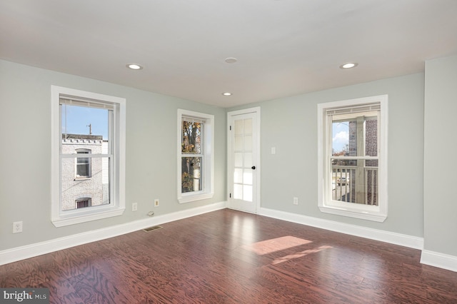 2621 E Monument St, Baltimore, MD 21205 - unfurnished room featuring dark wood-style floors, baseboards, and recessed lighting