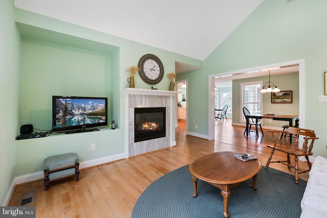 201 Pondview Ct, Chestertown, MD 21620 - living area with wood finished floors, a fireplace, high vaulted ceiling, baseboards, and a chandelier