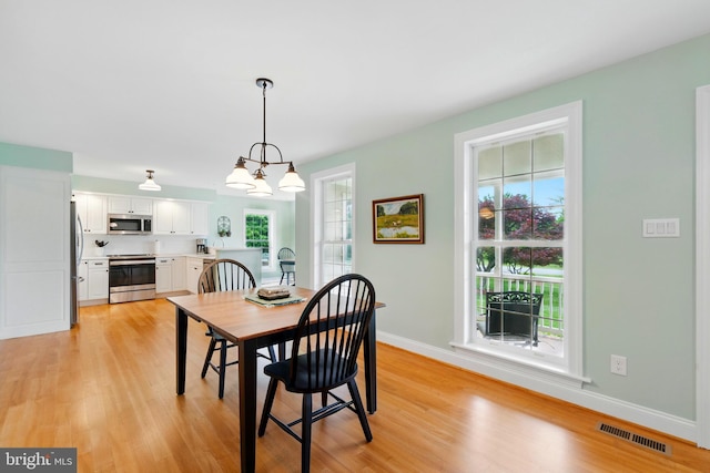201 Pondview Ct, Chestertown, MD 21620 - dining room featuring healthy amount of natural light, light wood-style flooring, baseboards, and a chandelier