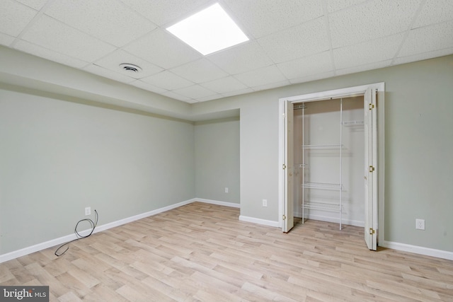201 Pondview Ct, Chestertown, MD 21620 - unfurnished bedroom with light wood-style flooring, a drop ceiling, baseboards, and a closet