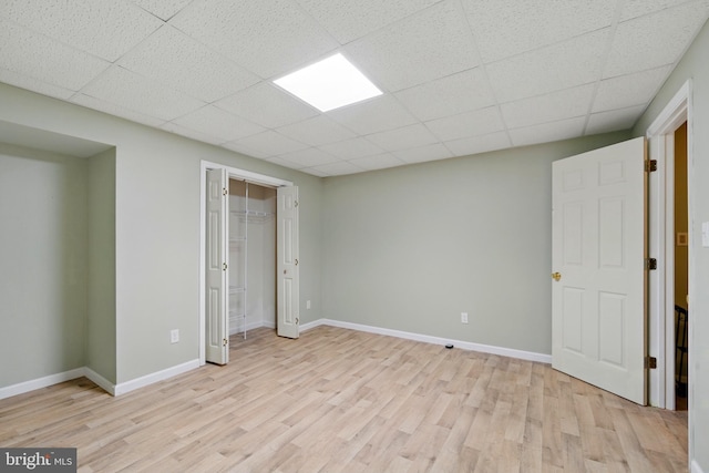 201 Pondview Ct, Chestertown, MD 21620 - unfurnished bedroom featuring light wood-style floors, baseboards, a drop ceiling, and a closet