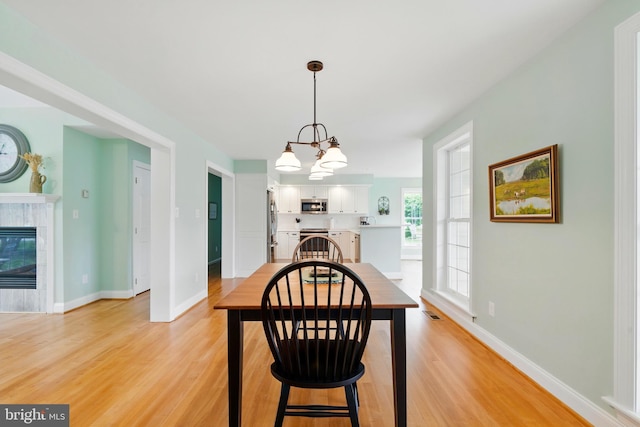 201 Pondview Ct, Chestertown, MD 21620 - dining space featuring light wood-style floors, baseboards, and a chandelier