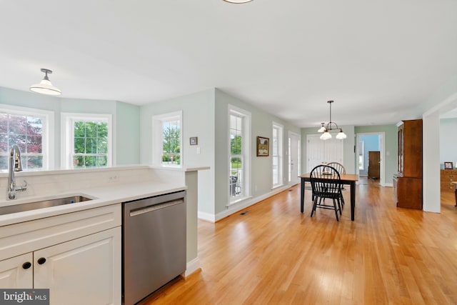 201 Pondview Ct, Chestertown, MD 21620 - kitchen featuring dishwasher, a sink, light wood-style flooring, light countertops, and white cabinets