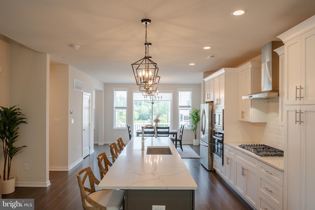 301 Star Tavern Ln, West Chester, PA 19382 - kitchen featuring a sink, wall chimney exhaust hood, stainless steel appliances, an island with sink, and a chandelier