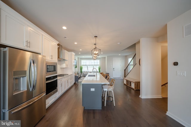 301 Star Tavern Ln, West Chester, PA 19382 - kitchen with stainless steel appliances, a sink, wall chimney exhaust hood, recessed lighting, and white cabinets