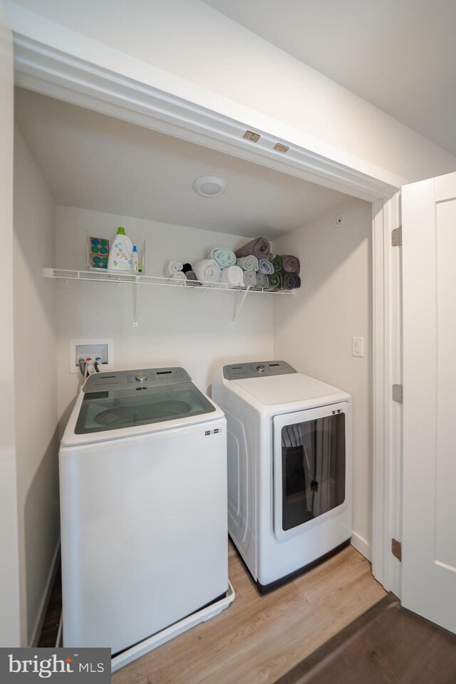301 Star Tavern Ln, West Chester, PA 19382 - laundry room with washing machine and clothes dryer and light wood finished floors