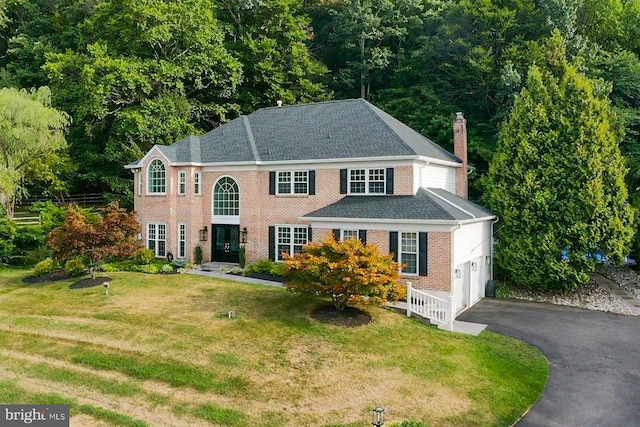2006 Par Dr, Doylestown, PA 18901 - georgian-style home featuring an attached garage, asphalt driveway, a front yard, brick siding, and a chimney