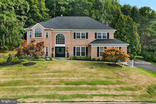 2006 Par Dr, Doylestown, PA 18901 - colonial-style house with french doors, a front lawn, brick siding, and a view of trees
