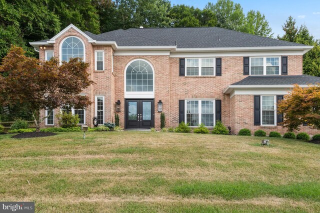2006 Par Dr, Doylestown, PA 18901 - view of front of home with french doors, a front yard, brick siding, and a shingled roof