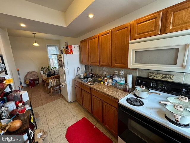 4635 Sansom St, Philadelphia, PA 19139 - kitchen with white appliances, a sink, brown cabinets, light tile patterned floors, and recessed lighting