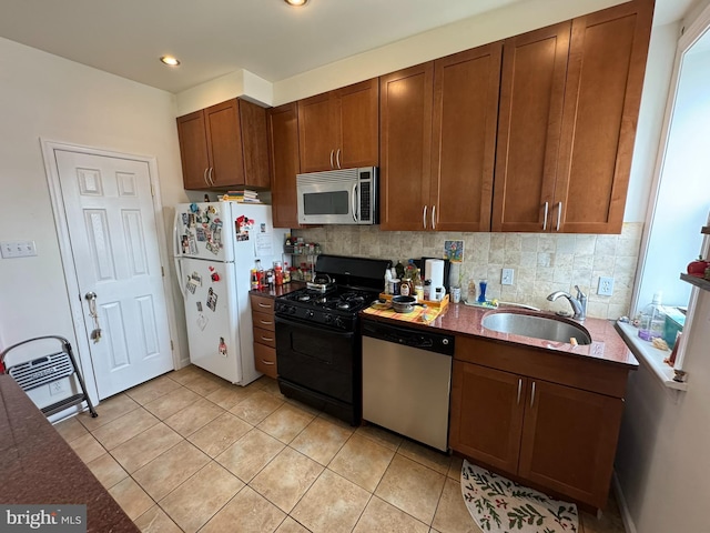 4635 Sansom St, Philadelphia, PA 19139 - kitchen featuring appliances with stainless steel finishes, a sink, backsplash, light tile patterned flooring, and recessed lighting