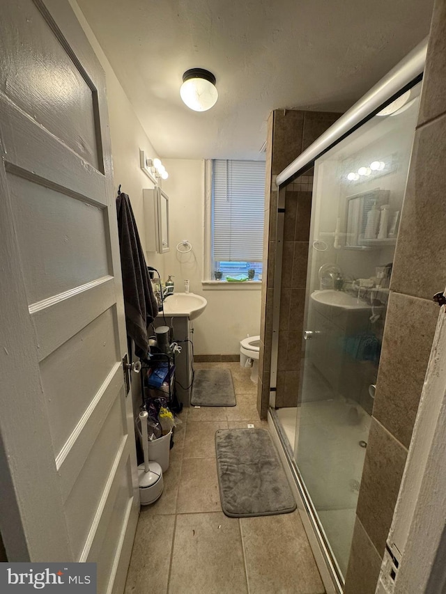 4635 Sansom St, Philadelphia, PA 19139 - full bathroom featuring toilet, tile patterned flooring, a shower stall, a sink, and baseboards