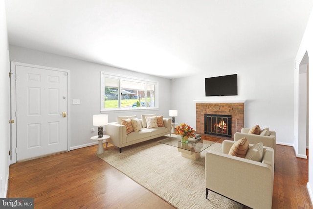 4503 Poppe Pl, Temple Hills, MD 20748 - living area featuring a fireplace, wood finished floors, and baseboards