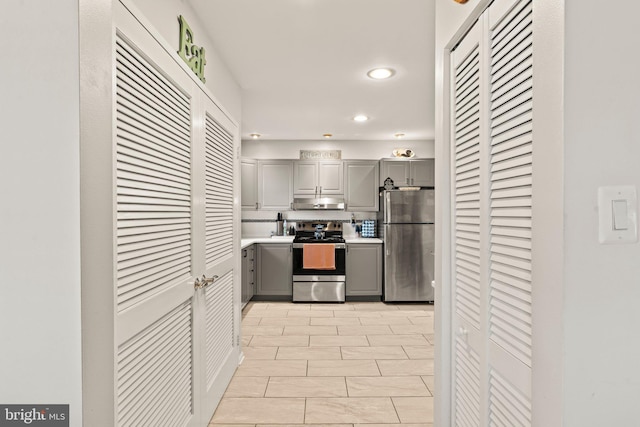 1019 Harbour, Palmyra, NJ 08065 - kitchen with gray cabinetry, stainless steel appliances, recessed lighting, light countertops, and under cabinet range hood
