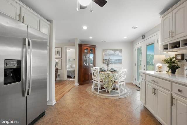 8588 King Carter St, Manassas, VA 20110 - kitchen with stainless steel refrigerator with ice dispenser, white cabinetry, baseboards, recessed lighting, and light countertops