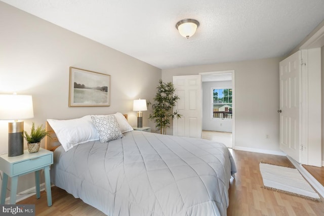 8588 King Carter St, Manassas, VA 20110 - bedroom featuring wood finished floors, baseboards, and a textured ceiling