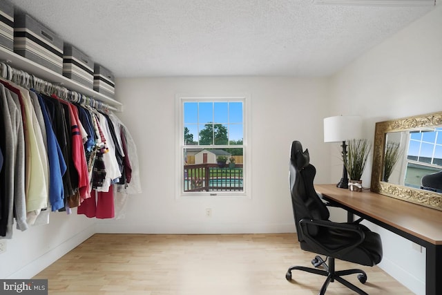 8588 King Carter St, Manassas, VA 20110 - home office featuring wood finished floors, a textured ceiling, and baseboards