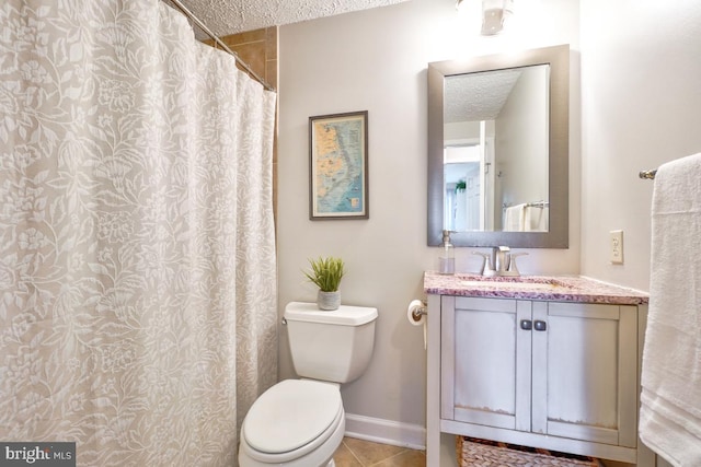 8588 King Carter St, Manassas, VA 20110 - full bathroom featuring a textured ceiling, toilet, vanity, tile patterned flooring, and baseboards