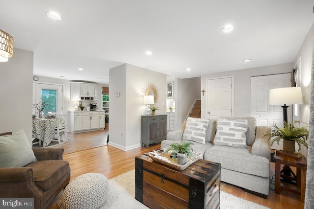 8588 King Carter St, Manassas, VA 20110 - living area featuring light wood-type flooring, stairs, recessed lighting, and baseboards