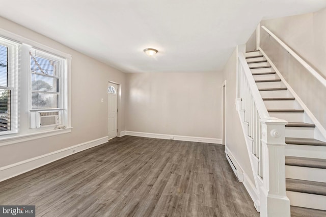 100 Chester Pike, Darby, PA 19023 - spare room featuring wood finished floors, stairs, baseboards, baseboard heating, and cooling unit