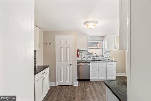 100 Chester Pike, Darby, PA 19023 - kitchen with stainless steel dishwasher, a sink, dark wood finished floors, tasteful backsplash, and white cabinets