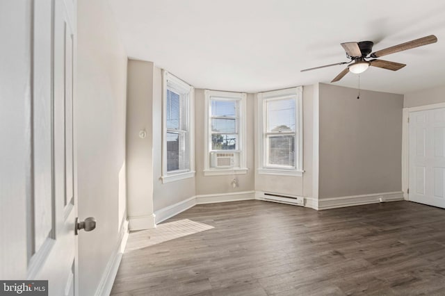 100 Chester Pike, Darby, PA 19023 - empty room featuring baseboard heating, baseboards, dark wood-type flooring, and ceiling fan