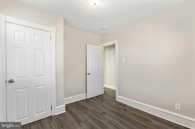 100 Chester Pike, Darby, PA 19023 - unfurnished bedroom featuring dark wood-style flooring and baseboards