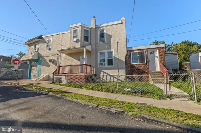 100 Chester Pike, Darby, PA 19023 - multi unit property with a fenced front yard, stucco siding, and a gate