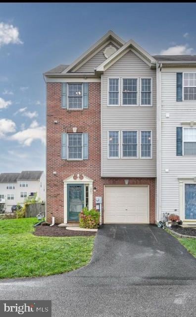241 Country Ridge Dr, Red Lion, PA 17356 - view of property featuring asphalt driveway, an attached garage, brick siding, and a front yard