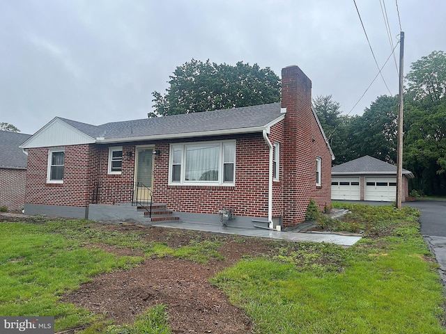 622 S Allison St, Greencastle, PA 17225 - view of front of home featuring brick siding, a chimney, a garage, an outbuilding, and roof with shingles