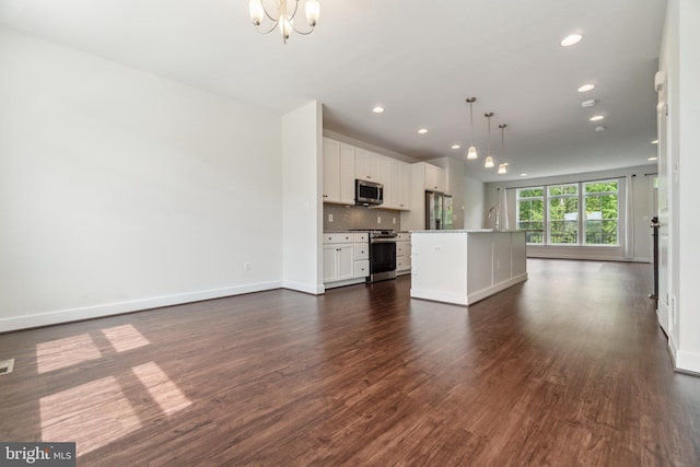 5163 Ridgeview Retreat Dr, Chantilly, VA 20151 - kitchen featuring appliances with stainless steel finishes, a chandelier, open floor plan, a kitchen island with sink, and dark wood-type flooring