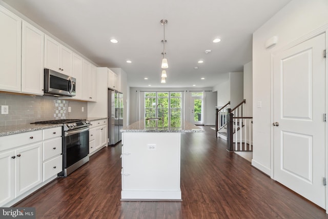 5163 Ridgeview Retreat Dr, Chantilly, VA 20151 - kitchen featuring appliances with stainless steel finishes, dark wood finished floors, white cabinets, recessed lighting, and light stone countertops