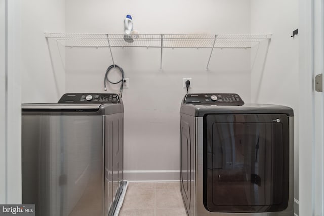 5163 Ridgeview Retreat Dr, Chantilly, VA 20151 - washroom with washer and clothes dryer, baseboards, and light tile patterned floors