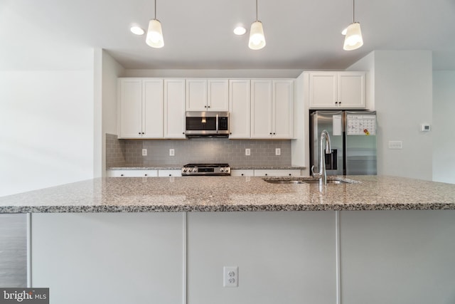 5163 Ridgeview Retreat Dr, Chantilly, VA 20151 - kitchen with stainless steel appliances, backsplash, white cabinetry, a kitchen island with sink, and light stone counters