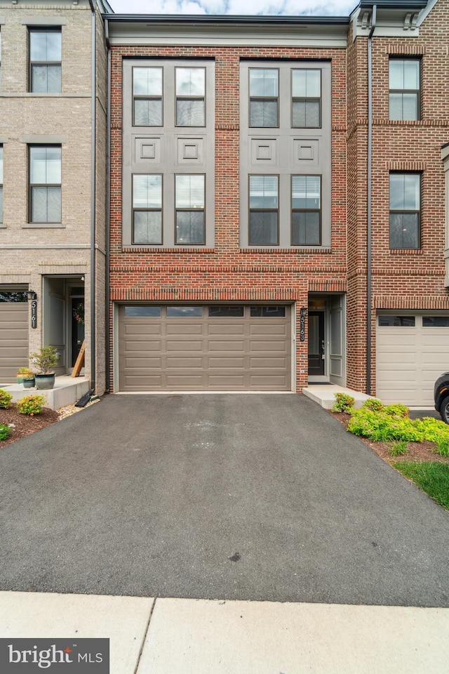 5163 Ridgeview Retreat Dr, Chantilly, VA 20151 - view of property featuring a garage, asphalt driveway, and brick siding