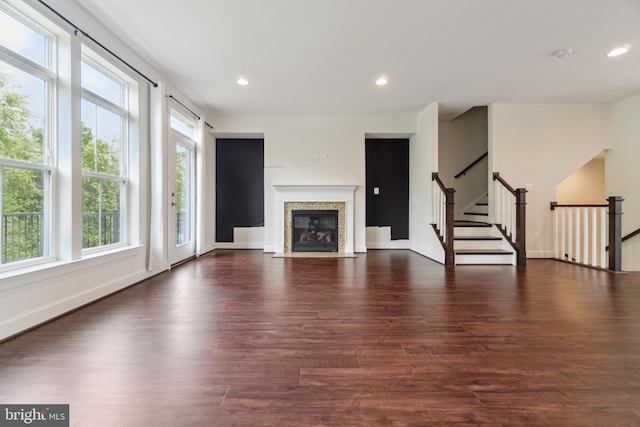 5163 Ridgeview Retreat Dr, Chantilly, VA 20151 - unfurnished living room featuring healthy amount of natural light, dark wood finished floors, recessed lighting, a fireplace with flush hearth, and stairs