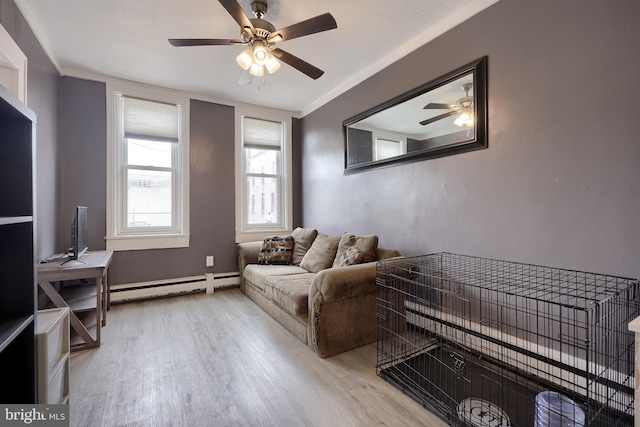 114 Walnut St, Columbia, PA 17512 - sitting room featuring a baseboard heating unit, wood finished floors, and ceiling fan