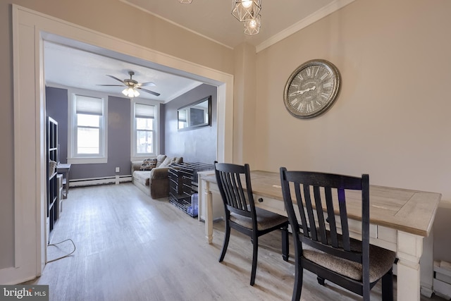 114 Walnut St, Columbia, PA 17512 - dining space featuring baseboard heating, crown molding, light wood-style flooring, and a ceiling fan