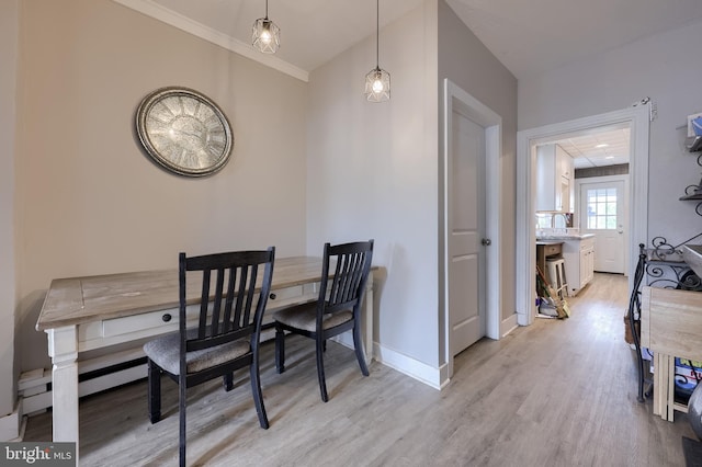 114 Walnut St, Columbia, PA 17512 - dining room featuring light wood-type flooring, baseboards, and crown molding