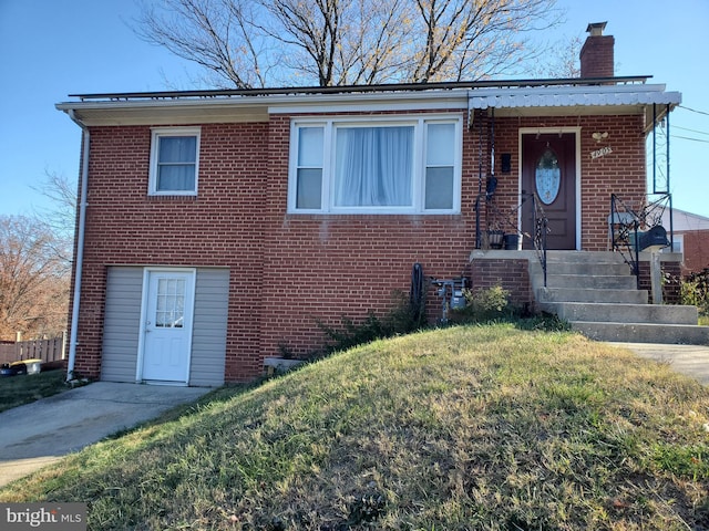 4905 66th Ave, Hyattsville, MD 20784 - view of front facade featuring a chimney, a front lawn, and brick siding