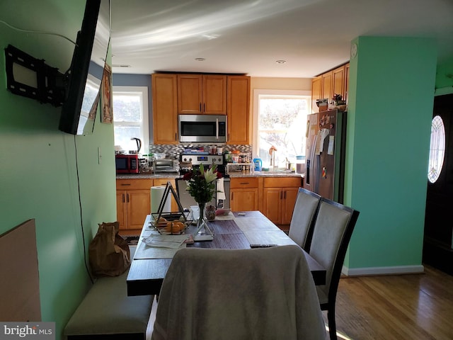 4905 66th Ave, Hyattsville, MD 20784 - kitchen with stainless steel appliances, healthy amount of natural light, wood finished floors, and backsplash