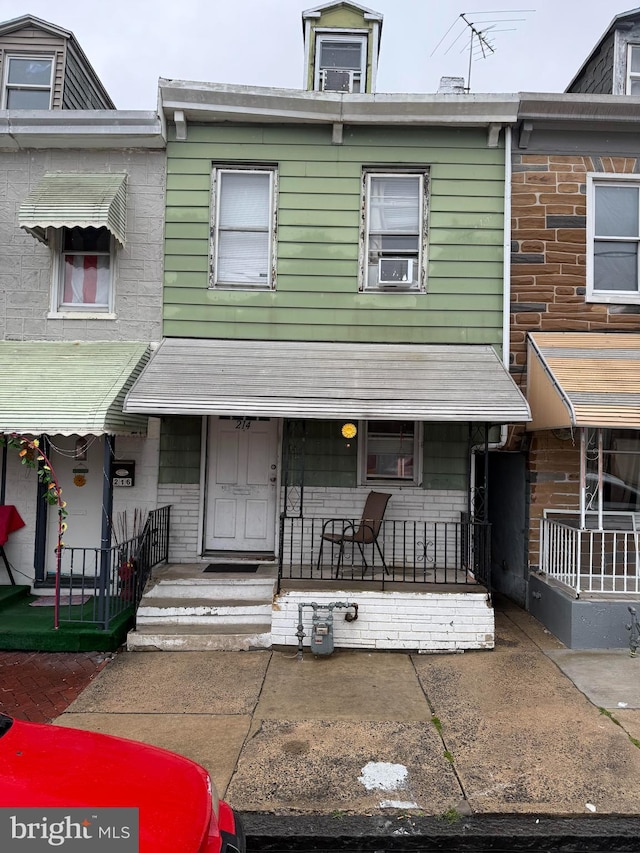 214 S 11th St, Reading, PA 19602 - view of property with cooling unit and a porch