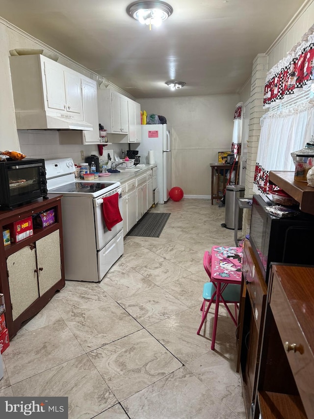 214 S 11th St, Reading, PA 19602 - kitchen with white appliances, white cabinets, under cabinet range hood, and a sink