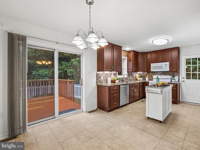 11 Duory Cir, Milton, DE 19968 - kitchen with white appliances, a chandelier, tasteful backsplash, and light stone countertops
