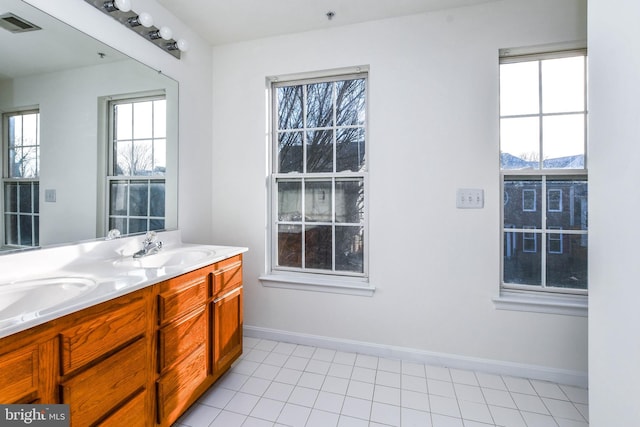 3313 Cornwell Dr SE, Washington, DC 20032 - bathroom featuring double vanity, plenty of natural light, tile patterned flooring, and baseboards