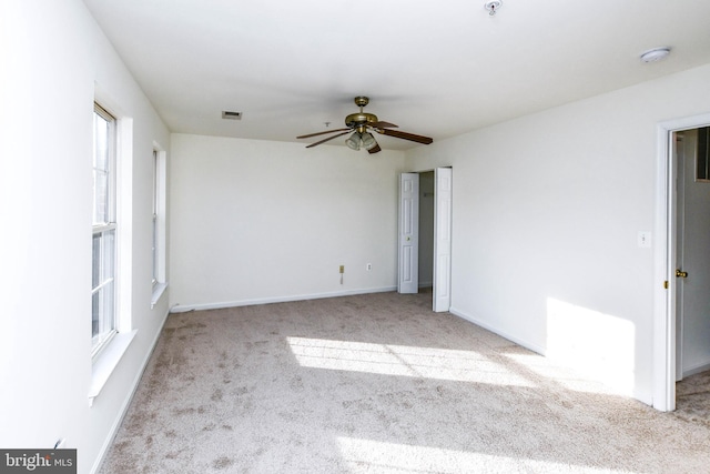 3313 Cornwell Dr SE, Washington, DC 20032 - carpeted empty room featuring a ceiling fan, plenty of natural light, baseboards, and a smoke detector