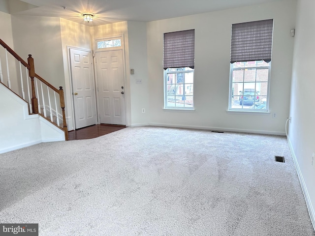3313 Cornwell Dr SE, Washington, DC 20032 - carpeted foyer featuring stairs and baseboards