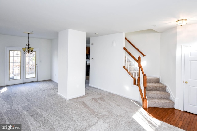 3313 Cornwell Dr SE, Washington, DC 20032 - unfurnished living room with stairway, a chandelier, carpet floors, and baseboards